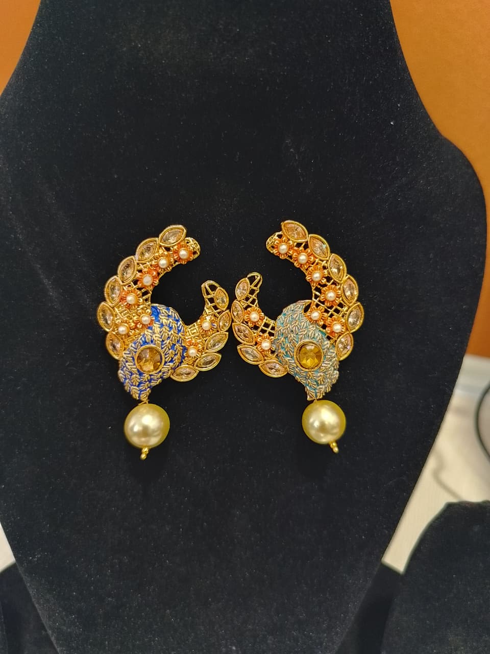 These are a pair of Indian ethnic earrings with a crescent moon design,