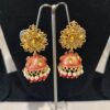 These are red Kundan Jhumka earrings.